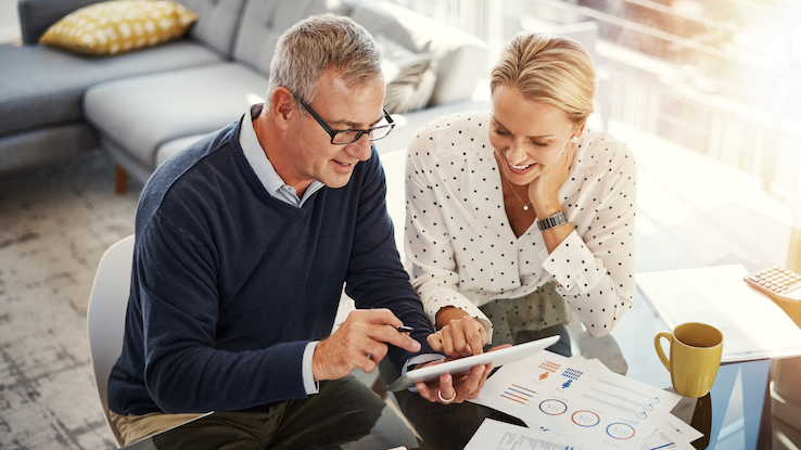 Couple at table planning open enrollment